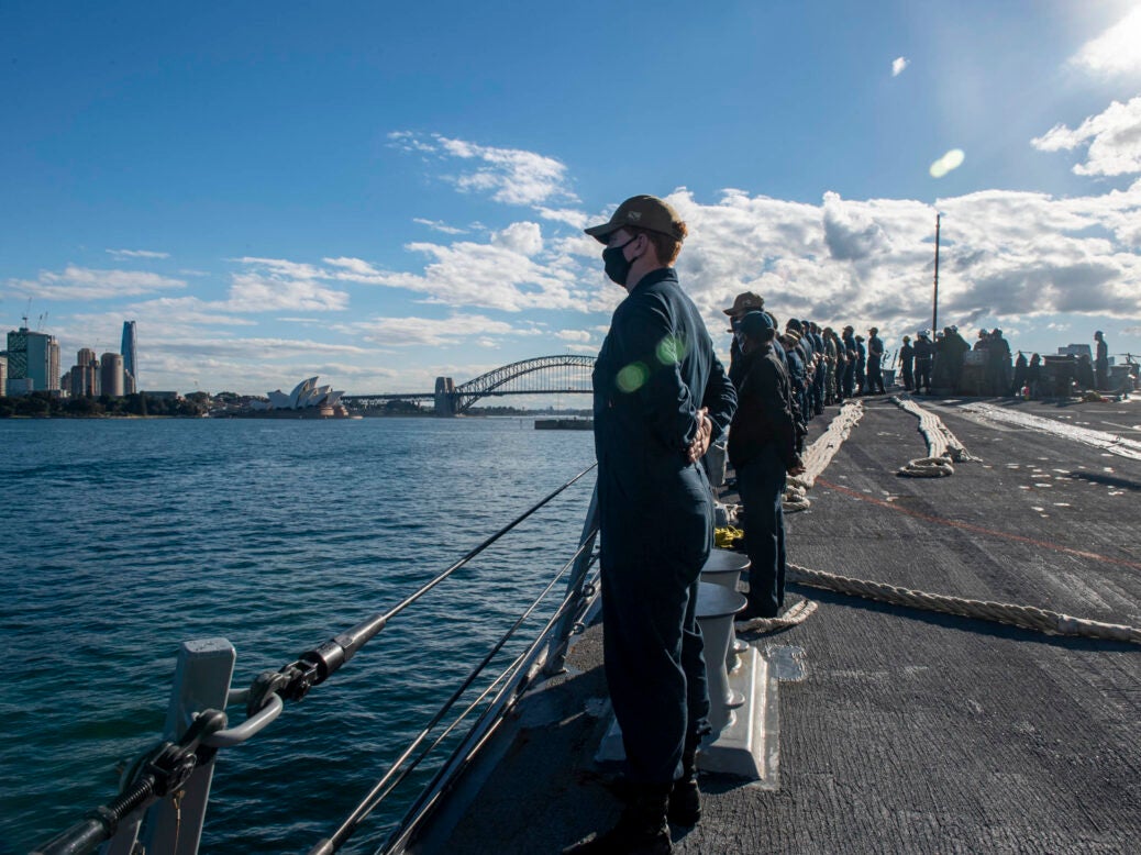 Sailors man the rails aboard USS Rafael Peralta (DDG 115) as they enter Sydney Harbor for Pacific Vanguard 2021